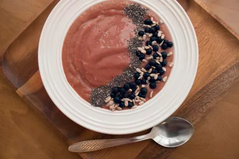 Smoothie bowl with blueberries and chia seeds on wooden background with a spo Stock Photos