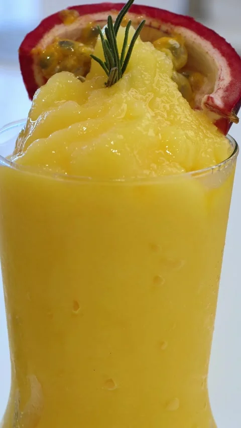 Smoothie mango passion fruit in a glass, fresh mango and passion fruit close-up. Stock Footage 333312955