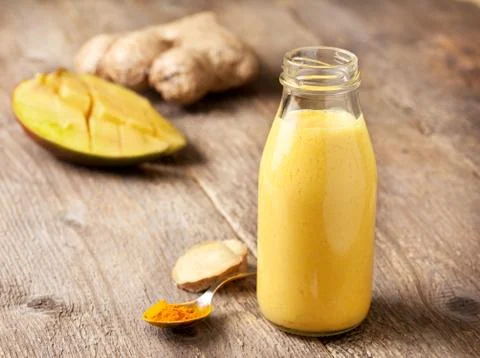 Smoothies with mango, ginger Stock Photos
