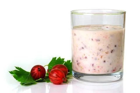 Smoothies with a red gooseberry berry on a white background Stock Photos