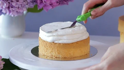 Smoothing the cream stuffing of the cake using confectionery spatula Stock Footage 102931987