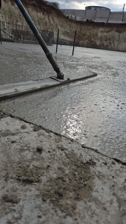 Smoothing freshly poured concrete side low angle view Stock Footage 335068765