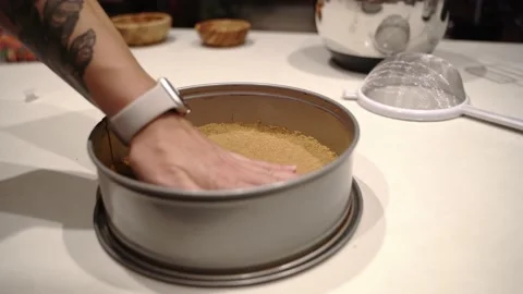 Smoothing out pie crust bottom inside of springform pan Stock Footage 222166445