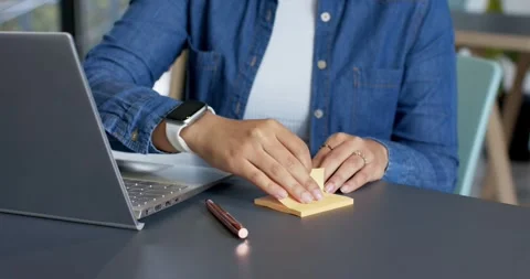 Smoothing pad, office worker is peeling note and colleague is placing it on Stock Footage 335866883
