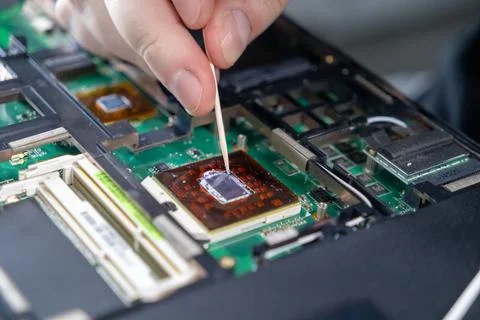 Smoothing thermal paste on a processor chip with a tool during computer assem Foto stock