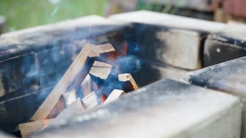 A smoothly burning fire in a brick area, close-up. Relaxing by the fire outside Stock Footage 258232970