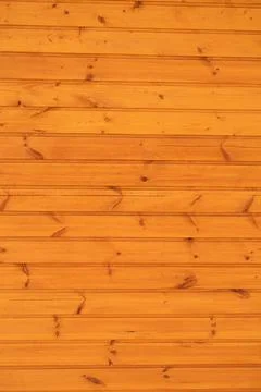 On a smoothly planed flat plank surface, many knots, a bright wood background Stock Photos