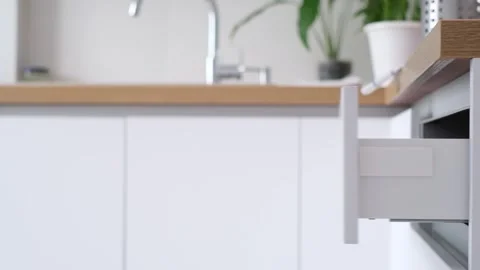 Smoothly slide the kitchen drawer with various kitchen utensils into the cutlery Stock Footage 315660861