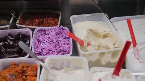 Smoothly top view shot with steadicam of different variants of fresh salads Stock Footage 183397229