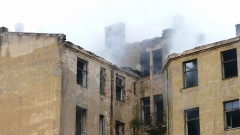 Smouldering structural fire on abandoned building Stock-Footage 99390535