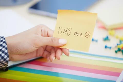 SMS me text on adhesive note Stock Photos