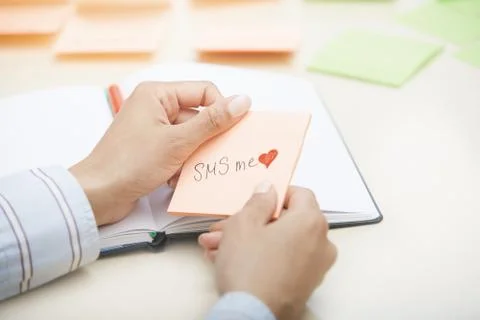 SMS me text on adhesive note Stock Photos