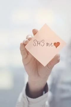 SMS me text on adhesive note Stock Photos