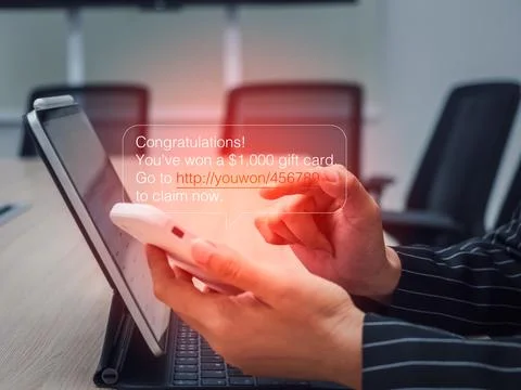 SMS scam message tricking users with a fake prize notification. A common ph.. Stock Photos