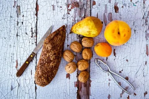 Snack with bread with cereals, walnuts, pear, peach and apricot Stock Photos
