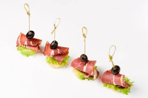 Snack canapes to the buffet on a white background Foto stock