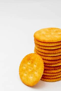 Snack concept, Crackers or biscuits arranged in vertical row isolated on whit Stock Photos