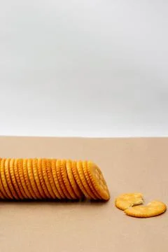 Snack concept, Crackers or biscuits arranged in a row and cracker scrap on th Stock Photos