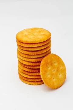Snack concept, Crackers or biscuits arranged in vertical row isolated on whit Photos