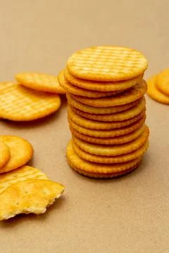 Snack concept, Crackers or biscuits arranged in vertical row and cracker scra Stock Photos