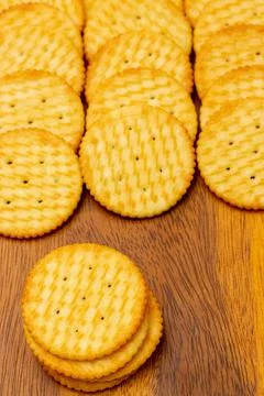 Snack concept, Crackers or biscuits arranged in vertical row and stacks on wo Stock Photos