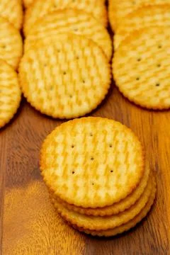 Snack concept, Crackers or biscuits arranged in vertical row and stacks on wo Stock Photos