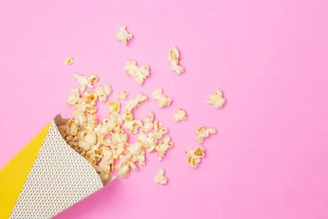 Snack concept, Sweet popcorn float out from paper cup on pink background Stock Photos