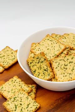Snack concept, Vegetable crackers or biscuits in bowl and saucer wooden on wh Stock Photos