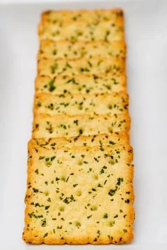 Snack concept, Vegetable crackers or biscuits arranged in row isolated on whi Stock Photos