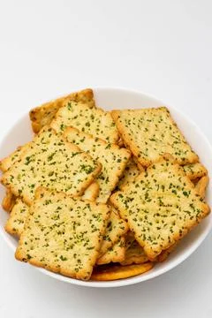 Snack concept, Vegetable crackers or biscuits in bowl isolated on white backg Stock Photos