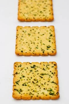 Snack concept, Vegetable crackers or biscuits arranged in row isolated on whi Stock Photos