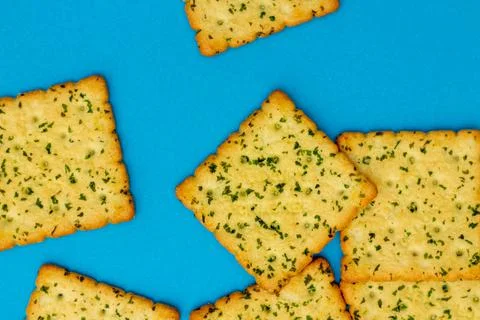 Snack concept, Vegetable crackers or biscuits stack isolated over light blue  Stock Photos