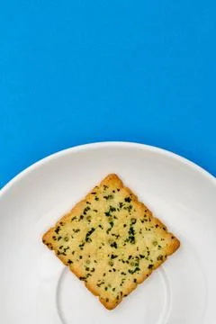 Snack concept, Vegetable crackers or biscuit in white plate isolated over lig Stock Photos