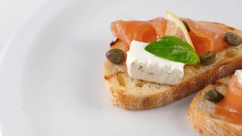 Snack or Appetizer, Toasted bread or Bruschetta with salmon Stock Footage 79925800