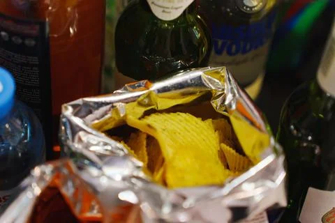 Snack time with chips and drinks at a gathering Stock Photos
