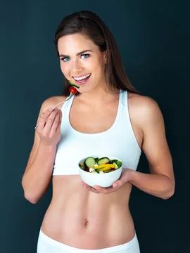 Snacking on something healthy. Studio portrait of an attractive young woman Stock Photos