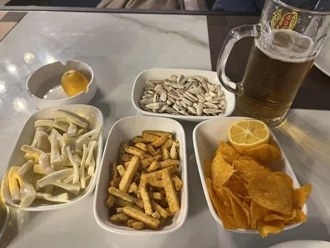 Snacks and beer on the table in a pub. Close up Stock Photos