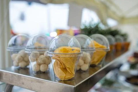 Snacks for beer in plastic packaging, chips in a cup Stock Photos