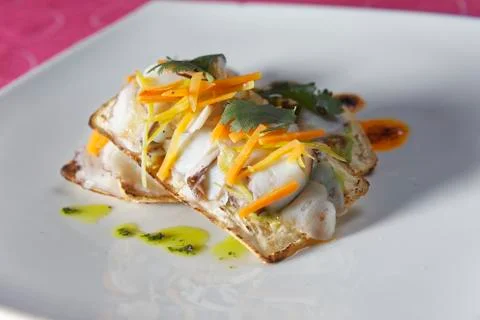 Snacks of fish fillets in mango sauce with strips of pepper served on cracker Stock Photos