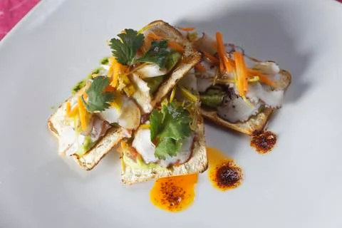 Snacks of fish fillets in mango sauce with strips of pepper served on cracker Stock Photos