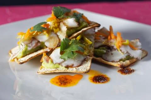Snacks of fish fillets in mango sauce with strips of pepper served on cracker Stock Photos