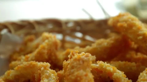 Snacks in the form of crispy fried onions served on the table Stock Footage 233764378