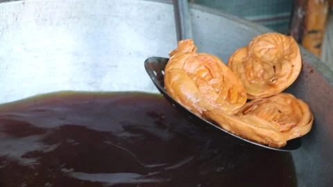 Snacks made of dough are fried in the hot oil Stock Footage 318967604