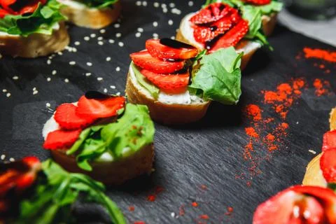 Snacks with meat and vegetables. Tapas with salmon and pickled cucumber. Pr.. Stock Photos