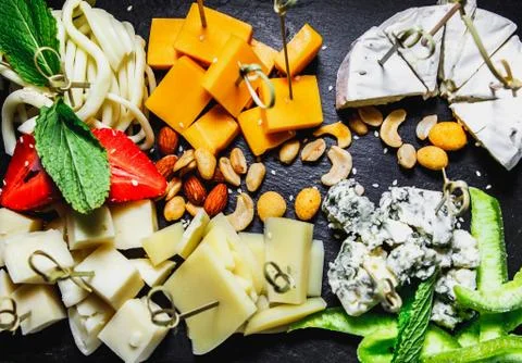 Snacks with meat and vegetables. Tapas with salmon and pickled cucumber. Pros Stock Photos