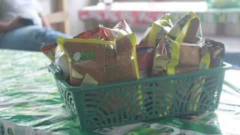 Snacks in a plastic basket placed on the table Stock Photos
