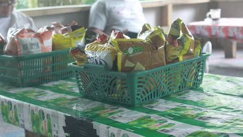 Snacks in a plastic basket placed on the table Stock Photos
