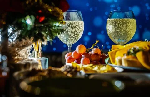 Snacks with sparky bubble wine on the buffet table with grapes. Cold beverage Stock Photos