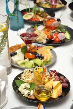 Snacks on the table in the restaurant: cheese, vegetable, fish, meat and frui Stock Photos