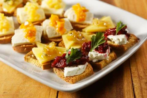 Snacks of toasted bread with Mozarella cheese, fresh cheese and Manchego chee Stock-Fotos